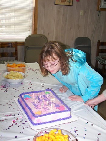 Brittany blowing out her candles on her 13th birthday cake