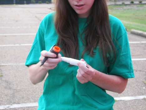 Elizabeth with a micro geocache container!